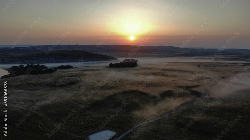 Beautiful sunset over the field and a river covered in fog. Beautiful sunset over the field and a river covered in fog.