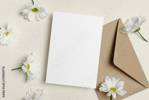 Blank invntation or greeting card mockup with envelope and flowers