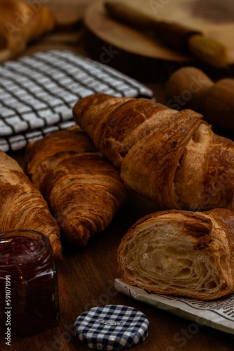 Closeup of tasty croissants baked in a cooker and served with raspberry jam