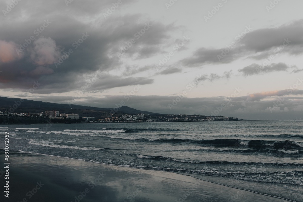 Fototapeta premium View of the seawater waves under the cloudy sky.