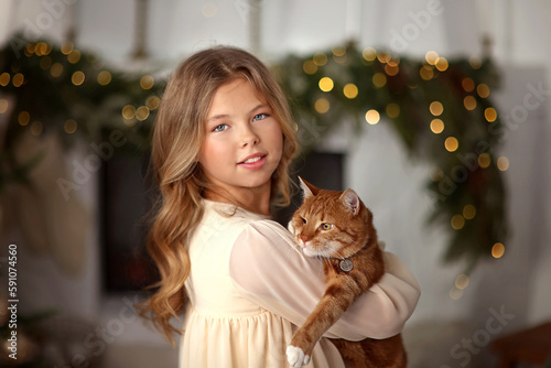 New Year. Christmas. beautiful girl in the New Year's room with a red cat in her hands. girl and cat