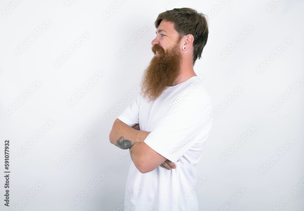 red haired man wearing white T-shirt over white studio background cross hands look copy space red haired man wearing white T-shirt over white studio background cross hands look copy space
