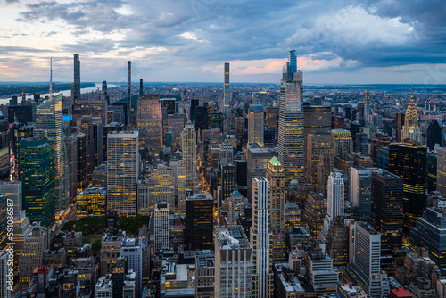 An illuminated midtown of New York City and rainy clouds above. photo