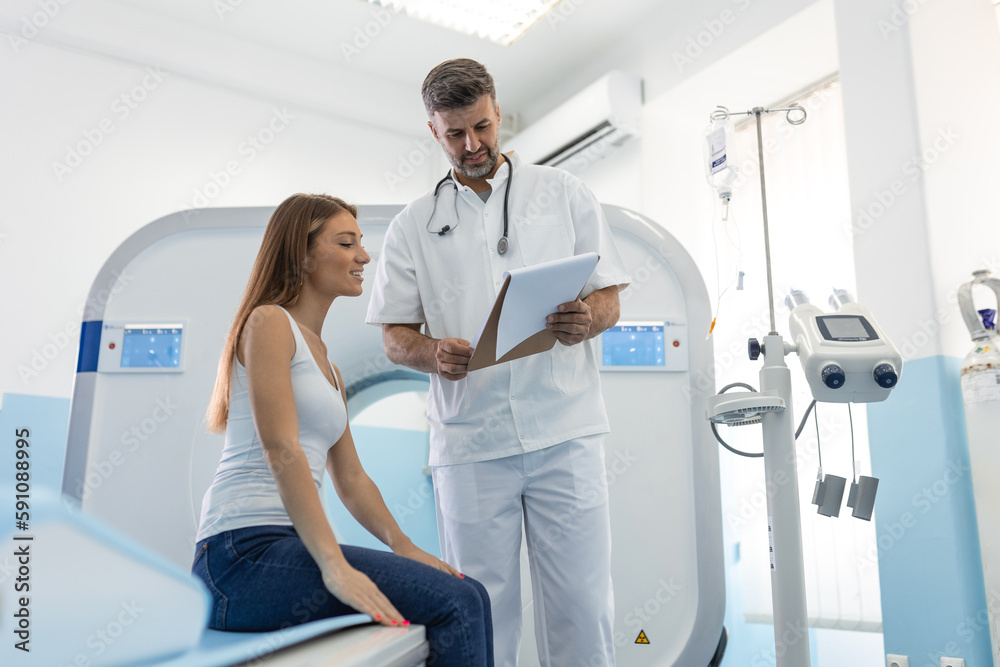 Female patient taking seat and asking questions about CT scan to crop medical practitioner after