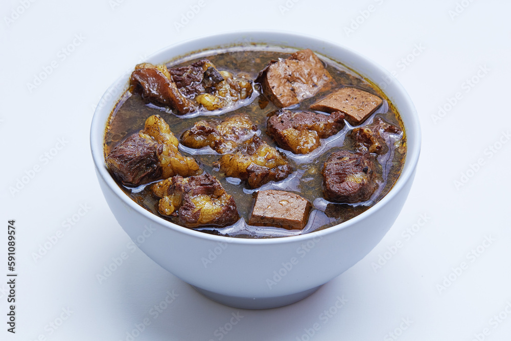 Rawon, Indonesian beef black soup. Originating from Surabaya, East Java. utilizes the black nut Keluak as the main seasoning, which gives a dark color to the soup. isolated white background Rawon, Indonesian beef black soup. Originating from Surabaya, East Java. utilizes the black nut Keluak as the main seasoning, which gives a dark color to the soup. isolated white background
