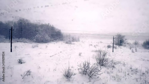 out train window in snow storm along tracks in ukraine photo
