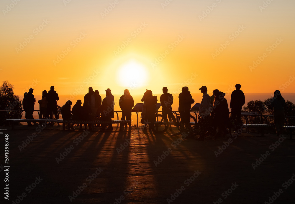 Fototapeta premium Silhouettes of people in sunset contour light, evening orange sun
