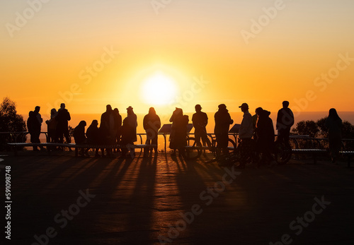 Silhouettes of people in sunset contour light, evening orange sun
