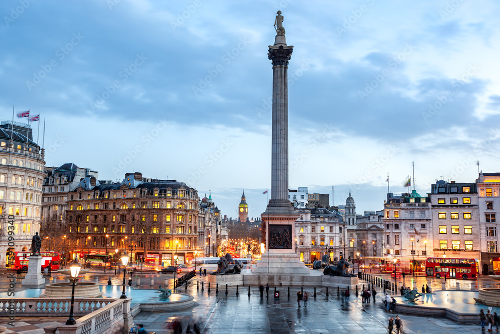 Nelson's Column is in the center of the square, flanked by fountains. At the top of the column is a statue of Horatio Nelson in UK