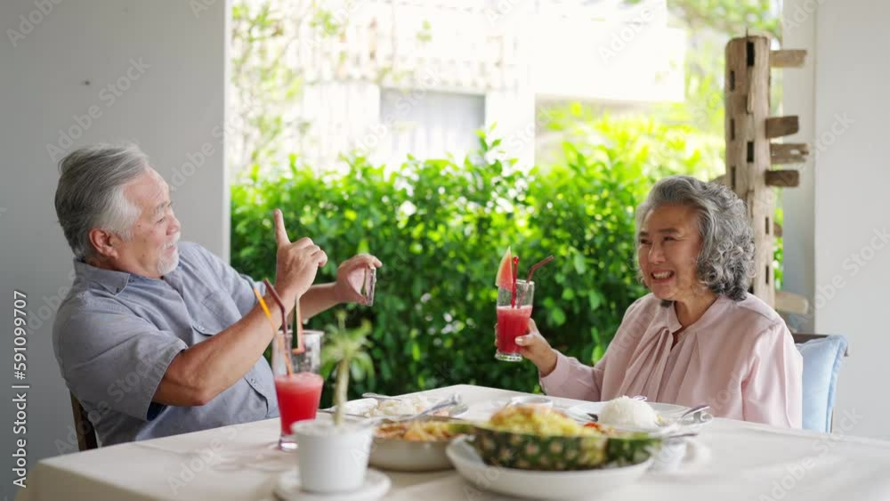 Happy Asian family senior couple having lunch and sharing meal together at restaurant. Elderly people man and woman enjoy retirement with outdoor activity lifestyle on summer holiday travel vacation. Happy Asian family senior couple having lunch and sharing meal together at restaurant. Elderly people man and woman enjoy retirement with outdoor activity lifestyle on summer holiday travel vacation.