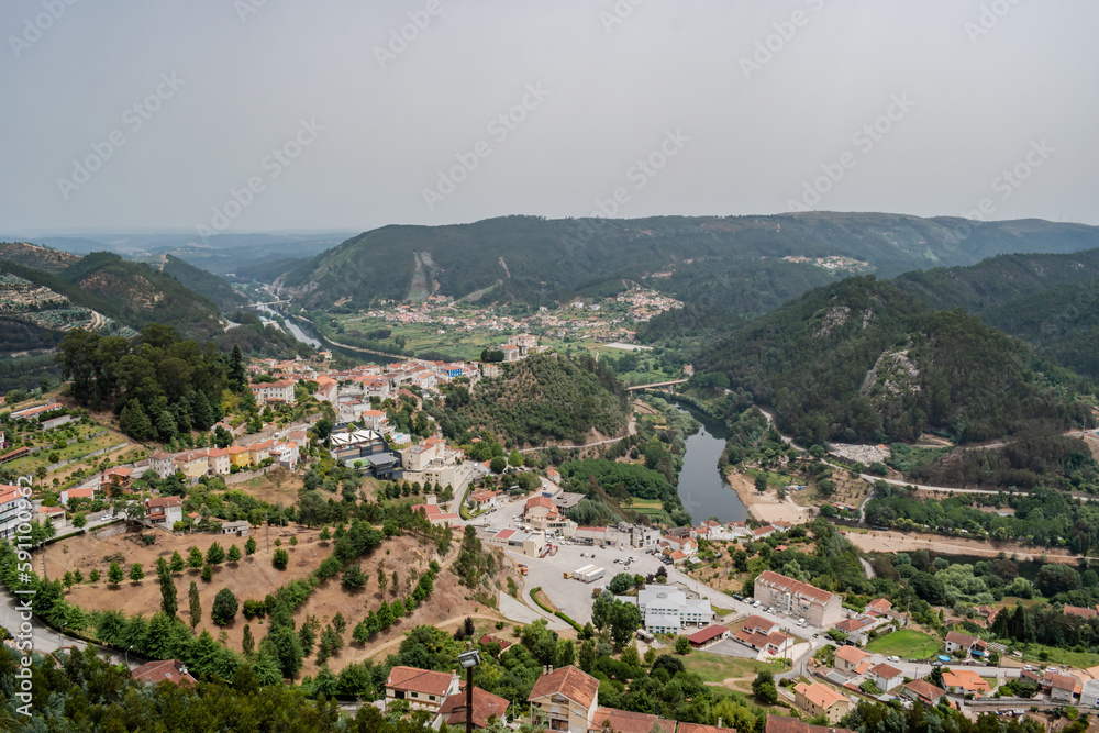 Houses and trees of Penacova village in aerial view with Mondego river between mountains, Coimbra PORTUGAL
