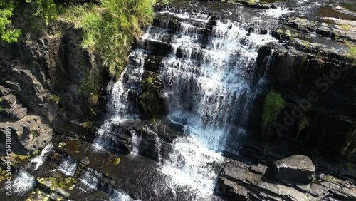 Beautiful drone footage above the famous Pongour waterfall in south Vietnam in Lam Dong province. Camera is descending along the site in the middle of green nature and rocks 2-3 photo