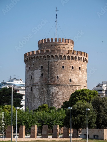 Vertical shot of old White Tower of Thessaloniki on blue sky background in Thessaloniki, Greece