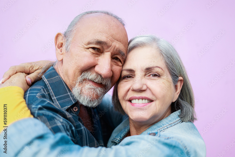 Portrait of happy senior couple hugging and looking at camera outdoor - Elderly joyful lifestyle Portrait of happy senior couple hugging and looking at camera outdoor - Elderly joyful lifestyle