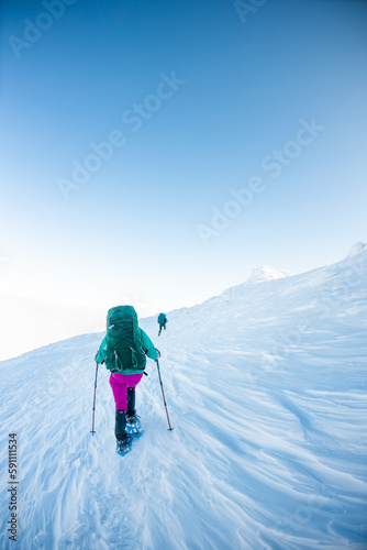 climbers climb to the top of the mountain in winter