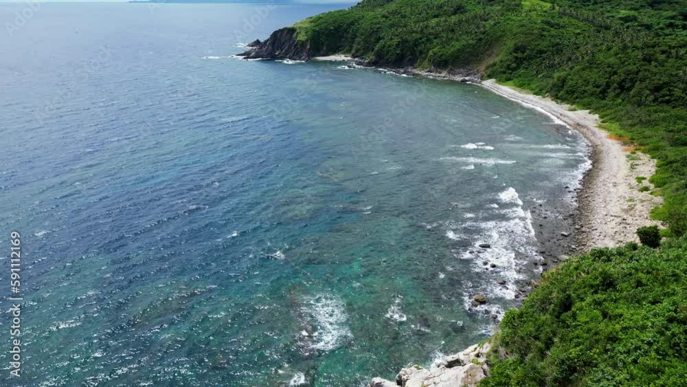 Beautiful sunny cove on tropical island with ocean waves on rocky shores Beautiful sunny cove on tropical island with ocean waves on rocky shores