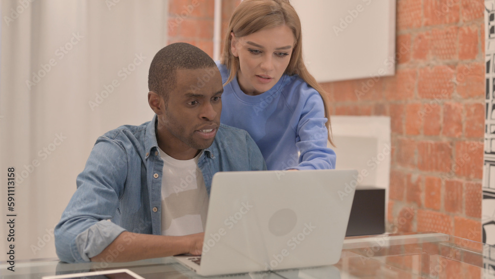 Interracial Couple Working on Laptop at Home Interracial Couple Working on Laptop at Home