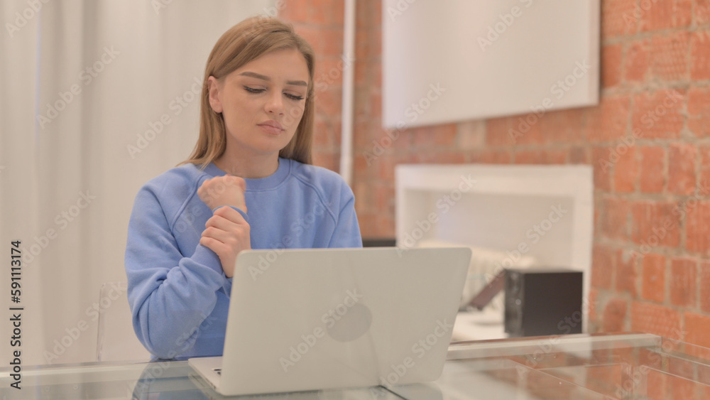 Young Woman with Wrist Pain Working on Laptop Young Woman with Wrist Pain Working on Laptop