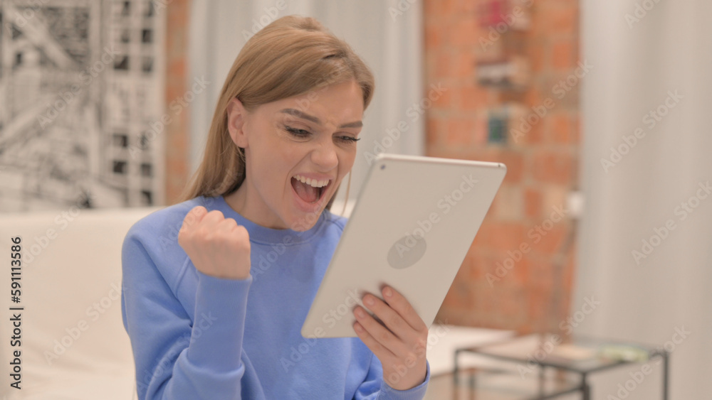 Portrait of Young Woman Celebrating Success on Tablet Portrait of Young Woman Celebrating Success on Tablet