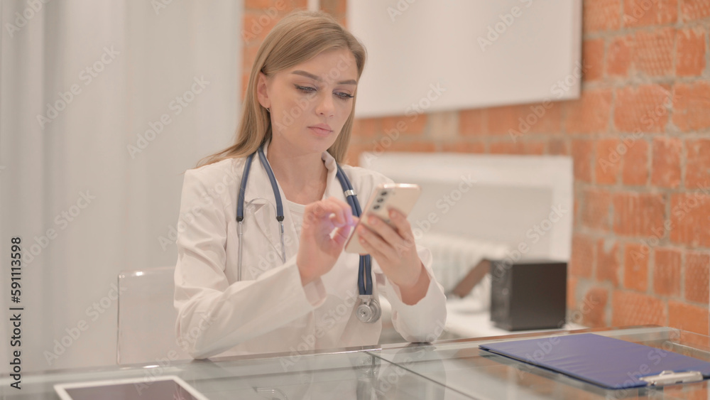 Female Doctor Using Smartphone in Clinic