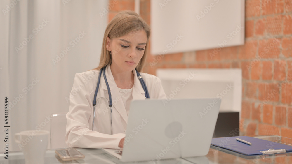 Female Doctor Working on Laptop in Clinic Female Doctor Working on Laptop in Clinic
