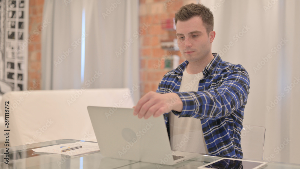 Young Casual Man Coming, Opening and Starting Work on Laptop 