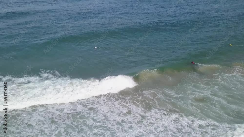 Bodyboarder performs rollo trick and rides through whitewash into barrel, aerial Bodyboarder performs rollo trick and rides through whitewash into barrel, aerial