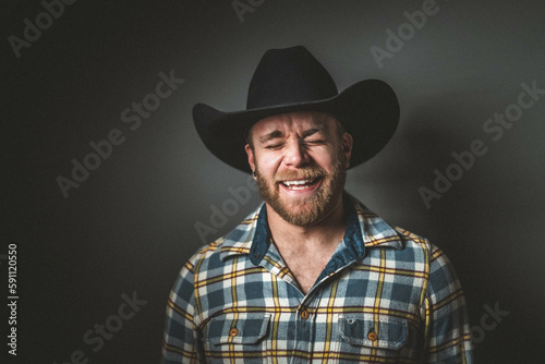Rugged man in cowboy hat.  Studio session.