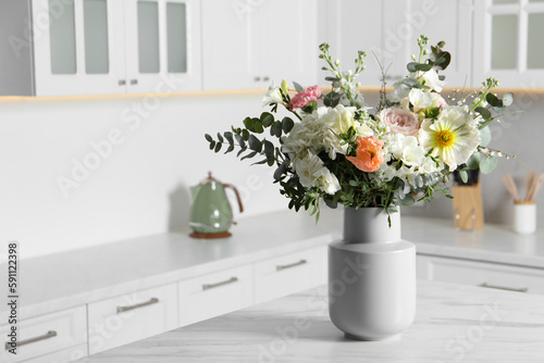Bouquet of beautiful flowers on white table indoors. Space for text