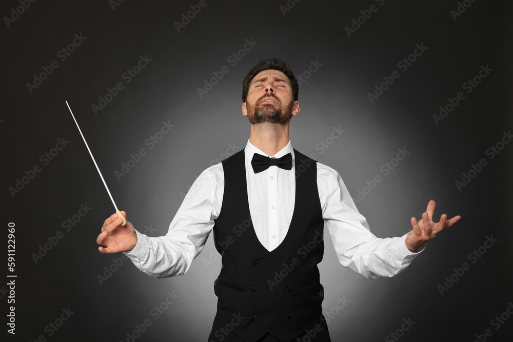 Professional conductor with baton on black background Professional conductor with baton on black background