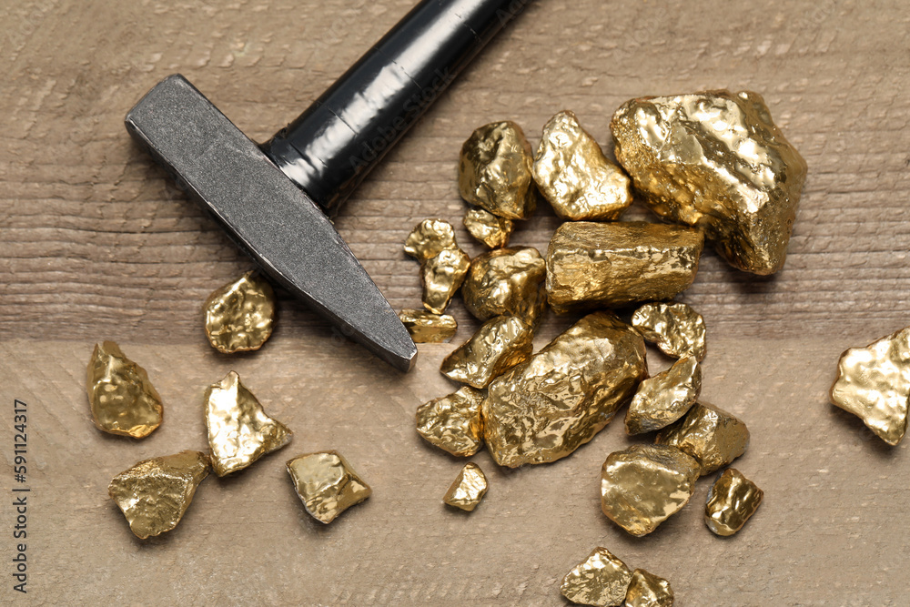custom made wallpaper toronto digitalPile of gold nuggets and hammer on wooden table, flat lay