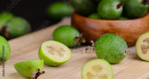 cut delicious sweet and sour green feijoa on the table, harvested a small amount of oriental feijoa fruit photo