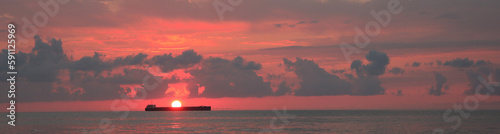 Beautiful sky with sun over sea at sunset, banner design. Ship sailing at sunset