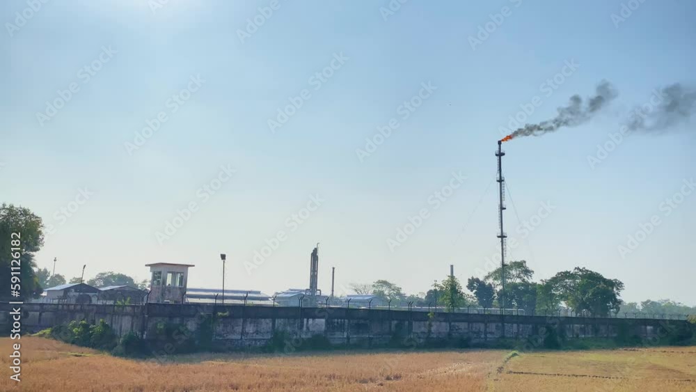 Establisher exterior view of Gas plant industry, torch and smokestack, day Establisher exterior view of Gas plant industry, torch and smokestack, day