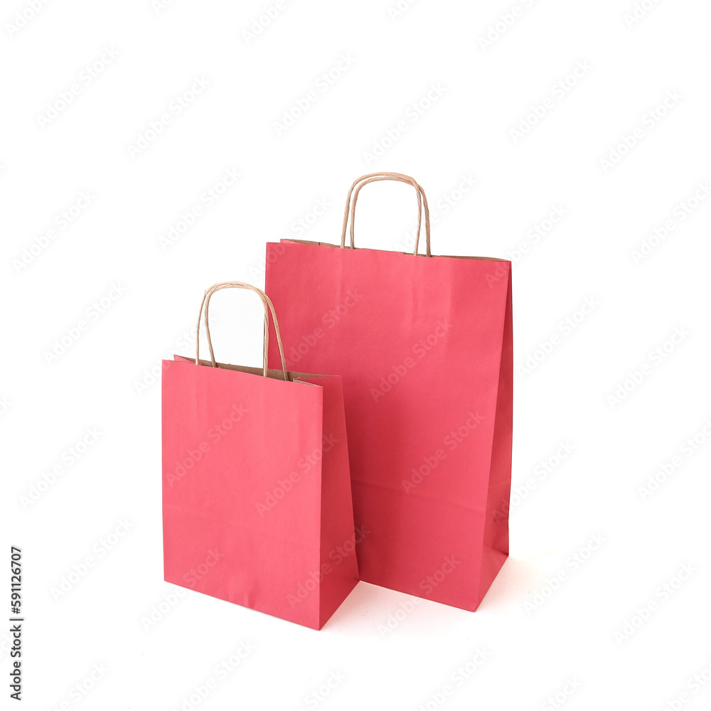 Red craft bags on a white background. Place for text and logo. The concept of packaging, gift, delivery. Red craft bags on a white background. Place for text and logo. The concept of packaging, gift, delivery.