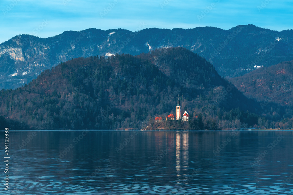 Lake Bled in cold february morning with famous landmark, the Assumption of Maria Church in background