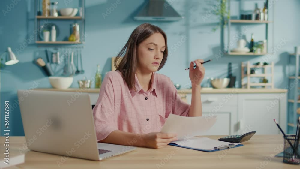 Frustrated Young Woman Accountant Use Calculator to Check Sums in Annual Report.Female Accountant Sit at Home Feeling Stressed About Bank Loan Payments.Make Payments On-line Through Secure Bank System Frustrated Young Woman Accountant Use Calculator to Check Sums in Annual Report.Female Accountant Sit at Home Feeling Stressed About Bank Loan Payments.Make Payments On-line Through Secure Bank System