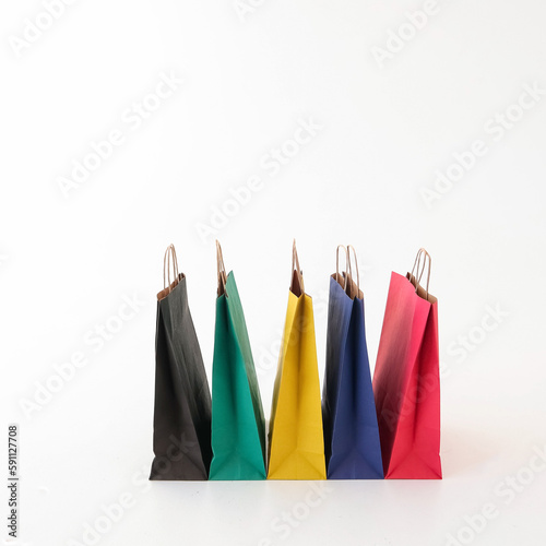 Colored craft bags on a white background. Place for text and logo. The concept of shopping, packaging, gift.