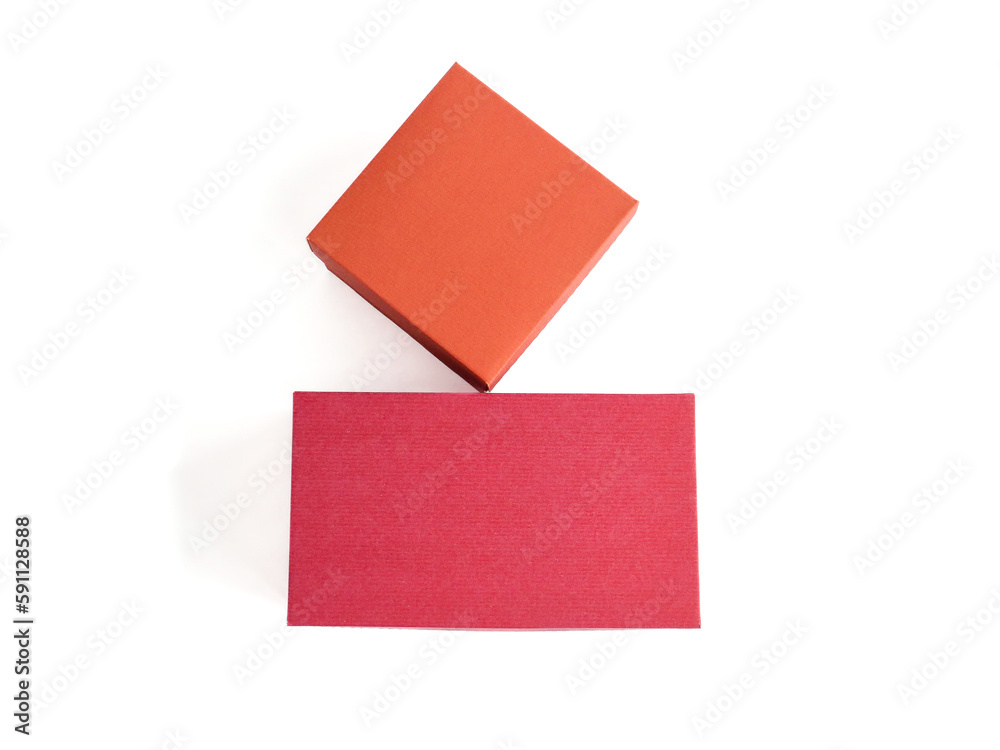 Red craft boxes of different sizes on a white background. The concept of gift, packaging, holiday. Place for text and logo. Top view. Red craft boxes of different sizes on a white background. The concept of gift, packaging, holiday. Place for text and logo. Top view.