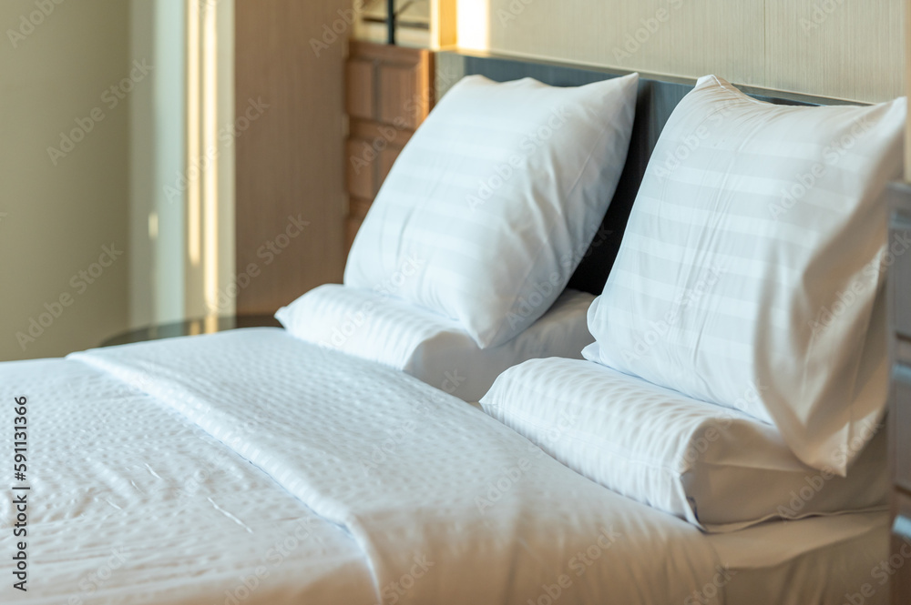 Soft pillows and white towel on clean white bed. Pillows bed with bedding sheets in bedroom. Bed sheets and pillows messed. Hotel, resort or home can relax on bed for deep sleep. Soft pillows and white towel on clean white bed. Pillows bed with bedding sheets in bedroom. Bed sheets and pillows messed. Hotel, resort or home can relax on bed for deep sleep.