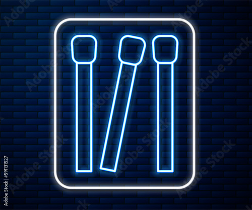 Glowing neon line Matches icon isolated on brick wall background. Vector