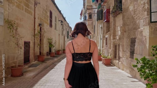 Female solo tourist feeling pretty walking on the streets of Valetta Malta photo