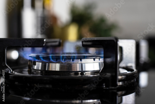 Modern kitchen stove cook. Gas flame close up on the gas stove.
