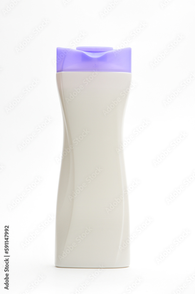 White plastic bottle for shampoo with a purple cap on a white background White plastic bottle for shampoo with a purple cap on a white background