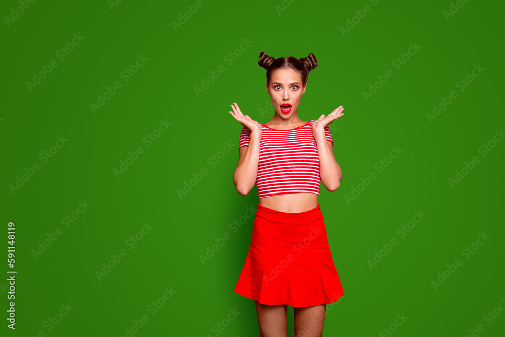 Sporty girl isolated on red background with copy space for text in red skirt and striped shirt impressed by good unexpected news Concept of human feelings Sporty girl isolated on red background with copy space for text in red skirt and striped shirt impressed by good unexpected news Concept of human feelings