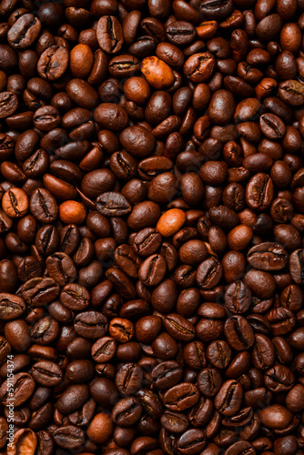 Background of roasted coffee beans. Macro photo. Free space for text. Top view.