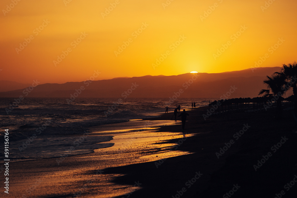 Vibrant and Serene Sunset View of the Ocean Beach with Golden Sunrays Reflecting on the Waves
