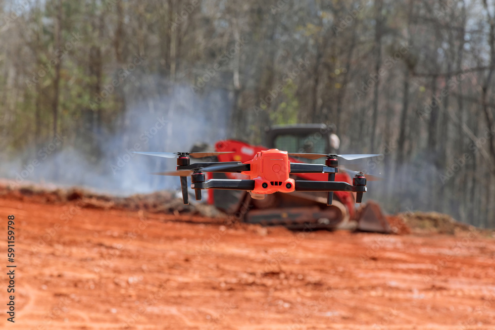 Obraz premium Engineer architect checks construction process at construction site with drone