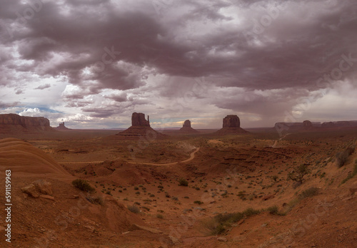 Monument Valley Navajo Tribal Park in Arizona, USA. View of a storm over the Sentinel Mesa, West Mitten Butte, East Mitten Butte, Merrick Butte, the Elephant Butte Monuments and Mitchell Mesa. photo