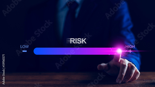 Risk management and chance to increase exposure for financial investment, projects, engineering, business. get maximum profit. Concept with manager's hand slide to high level. Fully open to risk. photo